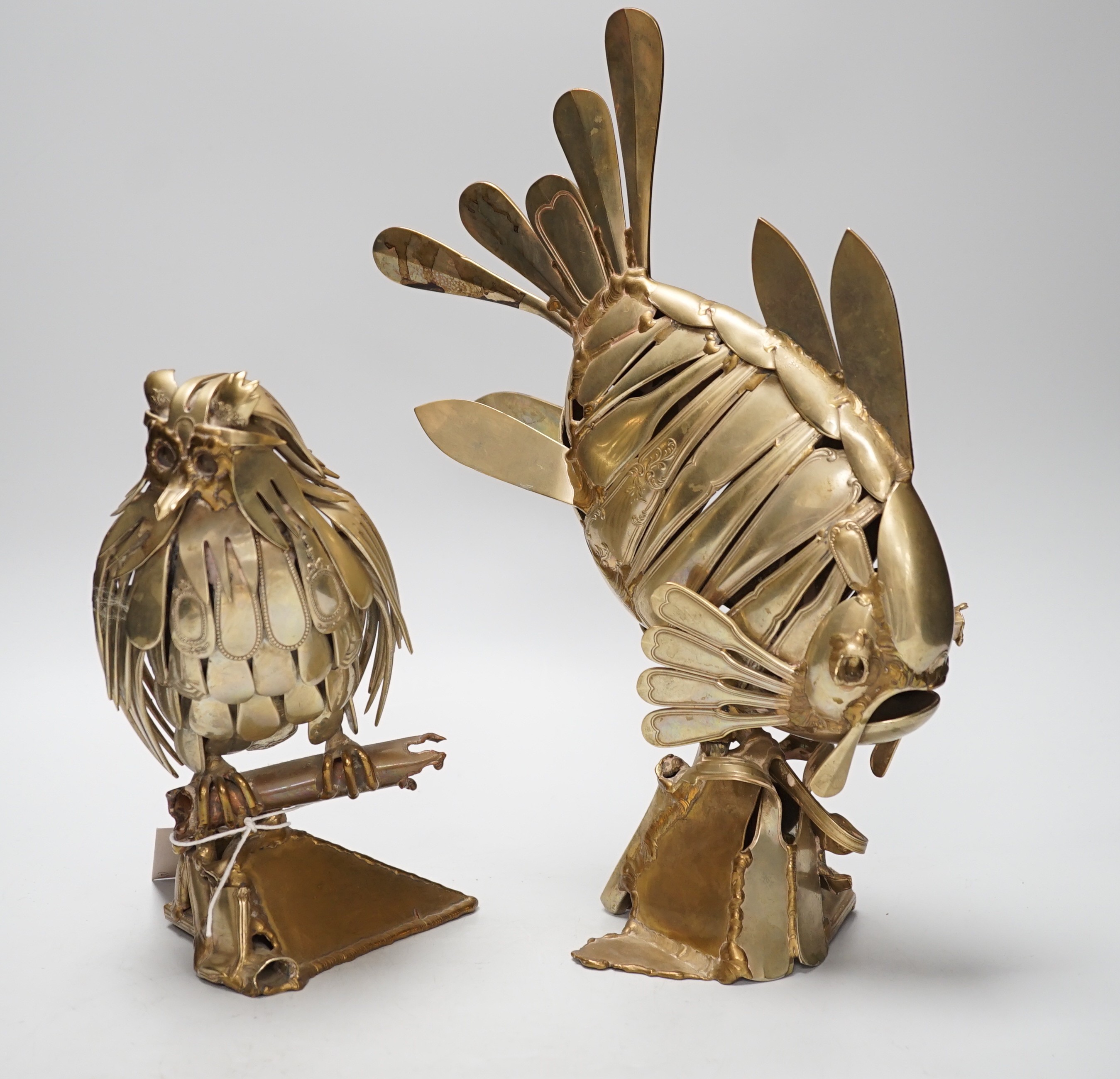 Two stylish nickel ornaments; an owl perching and an exotic fish, constructed from old knives and forks, one indistinctly signed and dated 1990, Tallest 35cm